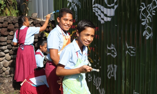 Students from Vaivase Primary School help paint the SPREP mural